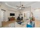 Cozy living room featuring a ceiling fan, and a large wall-mounted television at 6174 Spinnaker Loop, Lady Lake, FL 32159