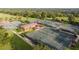 Aerial view of multiple tennis courts at a community, offering ample space for recreational activities and sports at 6174 Spinnaker Loop, Lady Lake, FL 32159