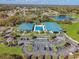 Community center aerial view featuring a pool, parking, and lush landscaping at 7451 Sw 111Th Pl, Ocala, FL 34476