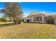 A sprawling backyard featuring lush landscaping, including a charming sunroom at 7451 Sw 111Th Pl, Ocala, FL 34476