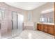 View of the bathroom with glass enclosed shower, jacuzzi tub and vanity at 7451 Sw 111Th Pl, Ocala, FL 34476