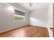 Bedroom with wood floors, a ceiling fan and a view from the bright window at 7451 Sw 111Th Pl, Ocala, FL 34476