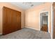 Bedroom with wall closet, neutral carpet and views from the bright window at 7451 Sw 111Th Pl, Ocala, FL 34476