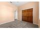 Cozy bedroom with closet, plush carpeting, and soft, neutral paint at 7451 Sw 111Th Pl, Ocala, FL 34476