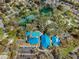 Aerial view of a community clubhouse with a sparkling pool, tennis courts, and other recreational amenities at 7451 Sw 111Th Pl, Ocala, FL 34476