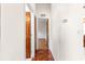 Hallway with patterned tile floor leading to a room with wood floors at 7451 Sw 111Th Pl, Ocala, FL 34476