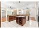 Open kitchen featuring granite countertops, central island with wine rack, and stainless steel appliances at 7451 Sw 111Th Pl, Ocala, FL 34476