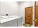 Bright laundry room featuring a washing machine and dryer and an accent fish rug at 7451 Sw 111Th Pl, Ocala, FL 34476