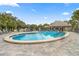 Community pool with a surrounding deck and comfortable lounge chairs at 7451 Sw 111Th Pl, Ocala, FL 34476