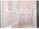 Walk-in shower with tile surround, glass block window, and built-in bench at 7451 Sw 111Th Pl, Ocala, FL 34476