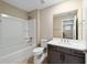 Bright bathroom featuring a shower-tub combo with updated vanity and hardware at 7821 Sw 55Th Ln, Ocala, FL 34474