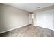 An empty bedroom with wood-look floors and a double-door closet at 7821 Sw 55Th Ln, Ocala, FL 34474