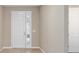 View of the light and bright entryway featuring beige walls and a traditional white door at 7821 Sw 55Th Ln, Ocala, FL 34474