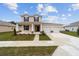 Charming two-story home with a welcoming front porch, a two-car garage, and landscaped front yard at 7821 Sw 55Th Ln, Ocala, FL 34474