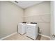 Laundry room with modern washer and dryer, plus convenient wire shelving at 7821 Sw 55Th Ln, Ocala, FL 34474