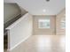 Bright living room featuring ceramic floors, neutral paint, and a staircase with wood steps at 7821 Sw 55Th Ln, Ocala, FL 34474