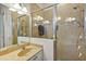 Bathroom featuring dual sinks, a shower stall, tile backsplash, and a large mirror at 8751 Sw 57Th Court Rd, Ocala, FL 34476