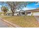 Street view of the front of the house with driveway, garage, porch, and lawn at 8891 Sw 96Th Ln # E, Ocala, FL 34481