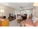 Cozy living room with neutral carpet, ceiling fan, and comfortable seating arrangement at 8891 Sw 96Th Ln # E, Ocala, FL 34481