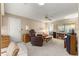 Living room area with neutral carpet, ceiling fan, a door, and comfortable seating arrangement at 8891 Sw 96Th Ln # E, Ocala, FL 34481