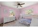 Charming bedroom with pink walls, a bunk bed, and a dresser with decorative accents at 8981 Sw Sw 209Th Cir, Dunnellon, FL 34431