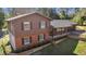 Exterior elevation of a two-story home with brown siding, brick accents, and a charming covered porch at 8981 Sw Sw 209Th Cir, Dunnellon, FL 34431