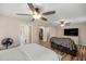 Bright and airy main bedroom with hardwood floors, ceiling fan, and access to an ensuite bathroom at 8981 Sw Sw 209Th Cir, Dunnellon, FL 34431