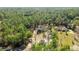 Beautiful aerial view of a home nestled among lush green trees in a wooded area at 8981 Sw Sw 209Th Cir, Dunnellon, FL 34431