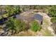 Aerial view of a home with a wooded lot and a dark roof at 8981 Sw Sw 209Th Cir, Dunnellon, FL 34431