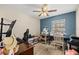 Bedroom featuring sewing station, blue accent wall and ceiling fan at 8981 Sw Sw 209Th Cir, Dunnellon, FL 34431