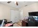 Bedroom with closet, light-toned paint, ceiling fan and wood floor at 8981 Sw Sw 209Th Cir, Dunnellon, FL 34431