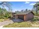 Two-story home with brick details, side-entry garage and brown siding at 8981 Sw Sw 209Th Cir, Dunnellon, FL 34431