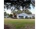 Spacious backyard with green grass, trees, and a well-maintained house exterior at 9133 Sw 91St Cir, Ocala, FL 34481