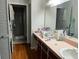 Well-lit bathroom with double vanity, ample countertop space, and a view into the walk-in shower at 9133 Sw 91St Cir, Ocala, FL 34481