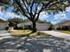 Charming single-story home featuring a lush front yard and a brick driveway leading to an attached two-car garage at 9133 Sw 91St Cir, Ocala, FL 34481