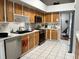 Bright and airy kitchen featuring stainless appliances, white tile floor, and light brown cabinetry at 9133 Sw 91St Cir, Ocala, FL 34481