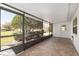 Relaxing screened patio with brick floors, backyard view, and an outdoor grill; perfect for entertaining or relaxing at 9133 Sw 91St Cir, Ocala, FL 34481