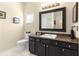 Clean bathroom with a dark vanity, black framed mirror, and shower at 9483 Sw 90Th St, Ocala, FL 34481