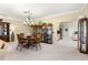 Elegant dining area with a wooden table set, chandelier, and built in display cabinets at 9483 Sw 90Th St, Ocala, FL 34481