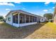 Rear exterior showing a large enclosed lanai and well maintained lawn at 9483 Sw 90Th St, Ocala, FL 34481