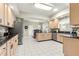 Well-lit kitchen with granite countertops, stainless steel appliances, and white tile flooring at 9483 Sw 90Th St, Ocala, FL 34481