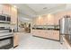 Spacious kitchen showcasing wooden cabinets, dark countertops, and stainless steel appliances at 9483 Sw 90Th St, Ocala, FL 34481