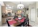 Eat-in kitchen area with stainless steel appliances, light wood cabinets, and an adjacent dining table at 9483 Sw 90Th St, Ocala, FL 34481