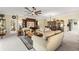 Comfortable living room featuring plush sofas, a ceiling fan, and views into the dining area at 9483 Sw 90Th St, Ocala, FL 34481