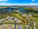 A full aerial view of the community shows lakes and lush greenery near the single story home at 1 Diamond Cove Pl, Ocala, FL 34472