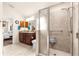 Bathroom featuring double sinks, vanity, walk-in shower and access to main bedroom at 1 Diamond Cove Pl, Ocala, FL 34472