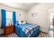 Bright bedroom featuring wood-look floors, a blue accent, and a white ceiling fan at 1 Diamond Cove Pl, Ocala, FL 34472