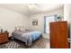 Cozy bedroom with neutral walls, wood-look floors, and a wooden dresser at 1 Diamond Cove Pl, Ocala, FL 34472