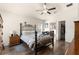 Bedroom featuring a wrought iron bed frame, ceiling fan, and wood flooring at 1 Diamond Cove Pl, Ocala, FL 34472