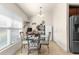 Kitchen nook featuring a glass table, and modern chairs illuminated by a stylish chandelier at 1 Diamond Cove Pl, Ocala, FL 34472